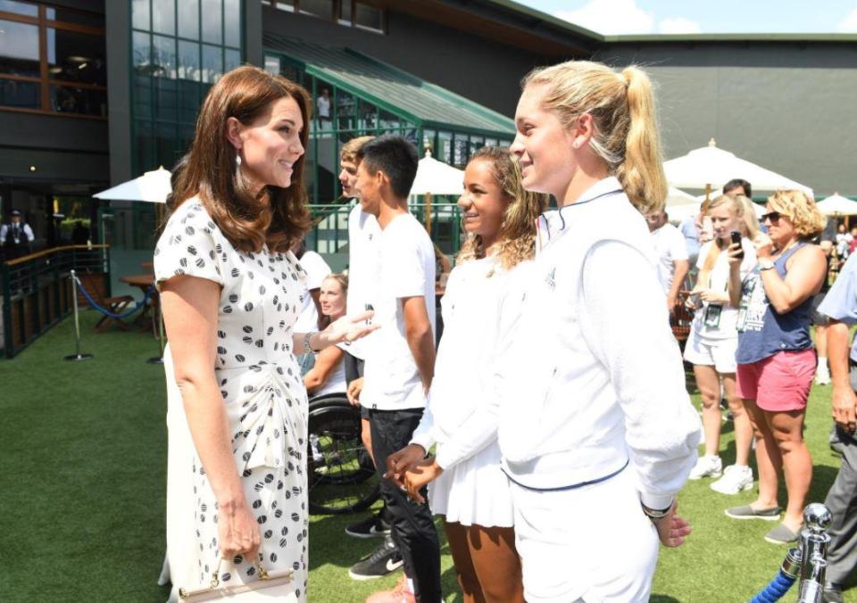  Keen tennis fan Kate rocked a ruffled midi dress as she swapped words with a junior player