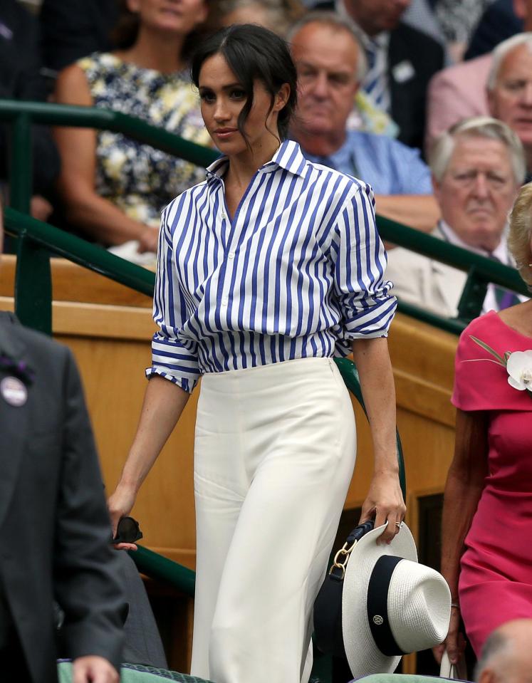 Meghan makes her way to her seat at Wimbledon