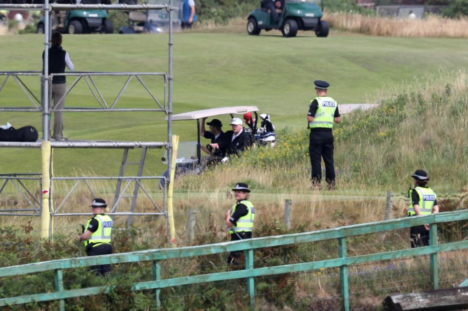  Police surrounded the president as he enjoyed a round of golf on the course, kitted out in a white USA baseball cap