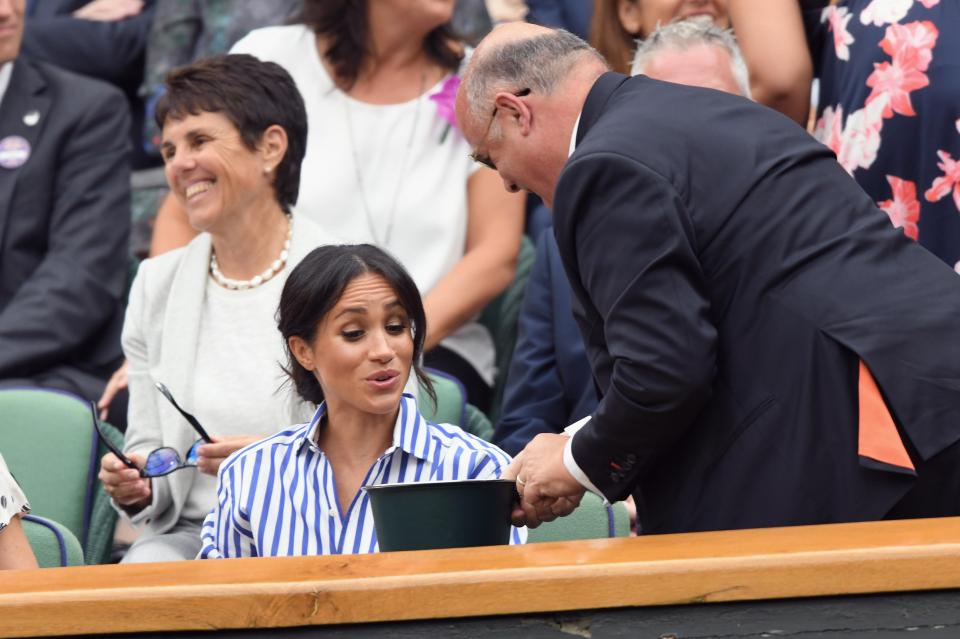  Meghan is offered some sweets, a tradition of the Royal Box