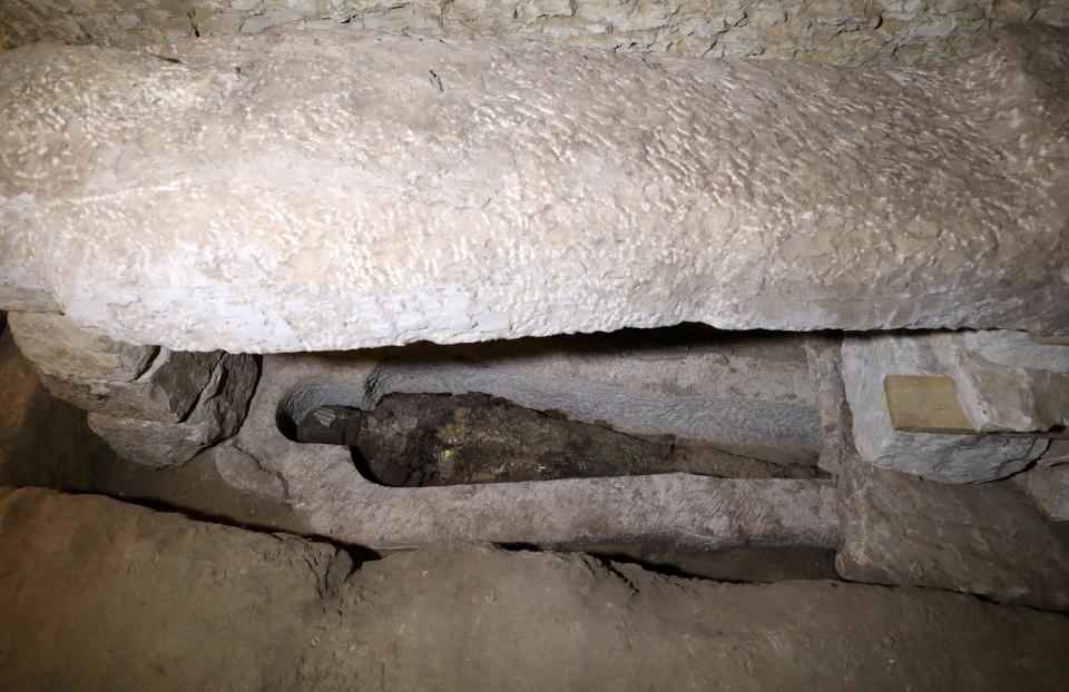  A mummy is seen inside the newly discovered burial site near Egypt's Saqqara necropolis