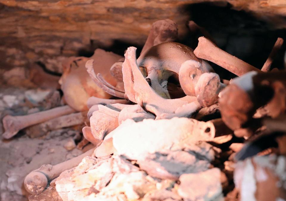  A skull and bones are seen inside a recently discovered burial shaft