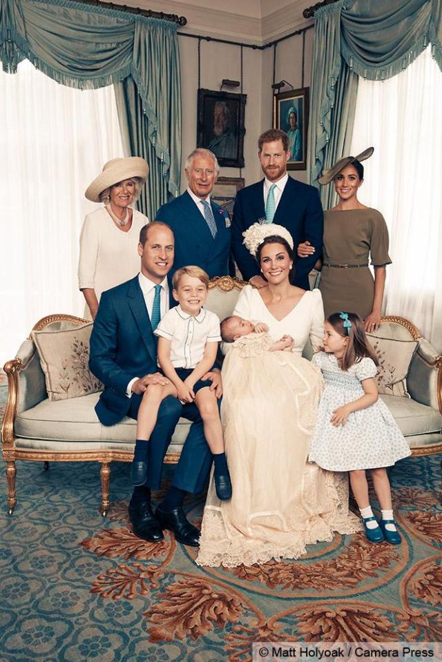  The official snaps show proud mum Kate holding Louis as Prince George beams from dad William's lap and Charlotte gazes at the new arrival