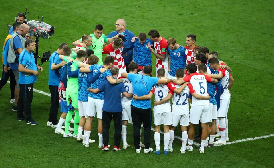 Croatia huddled on the pitch after the game after their valiant effort