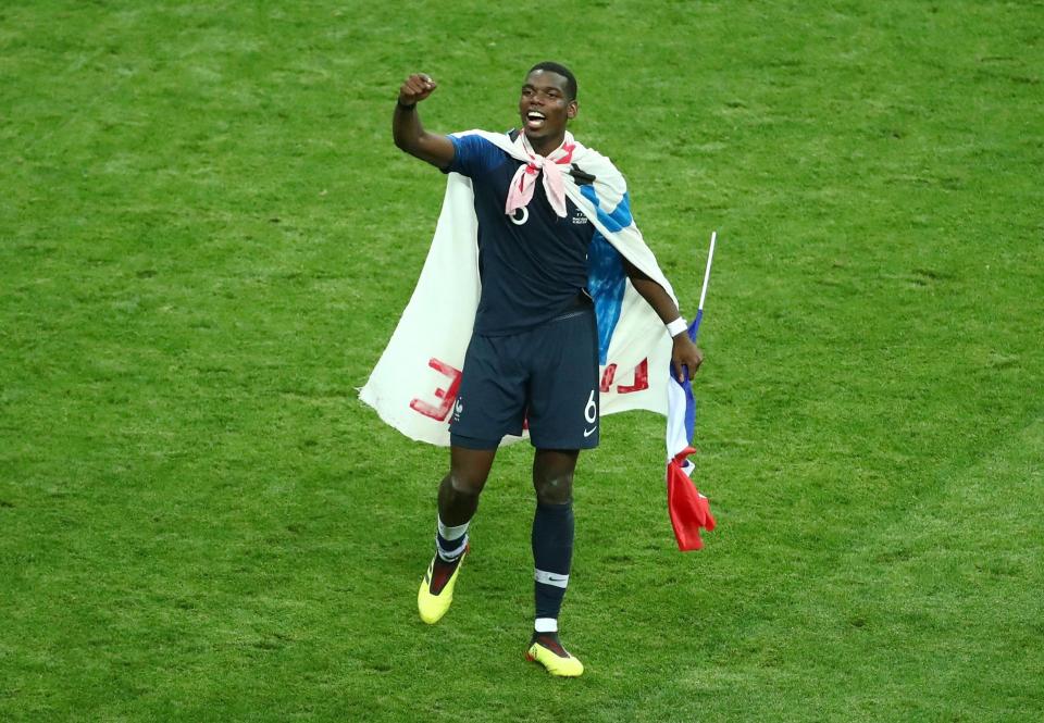 Paul Pogba celebrated wrapped in a France flag after his superb performance