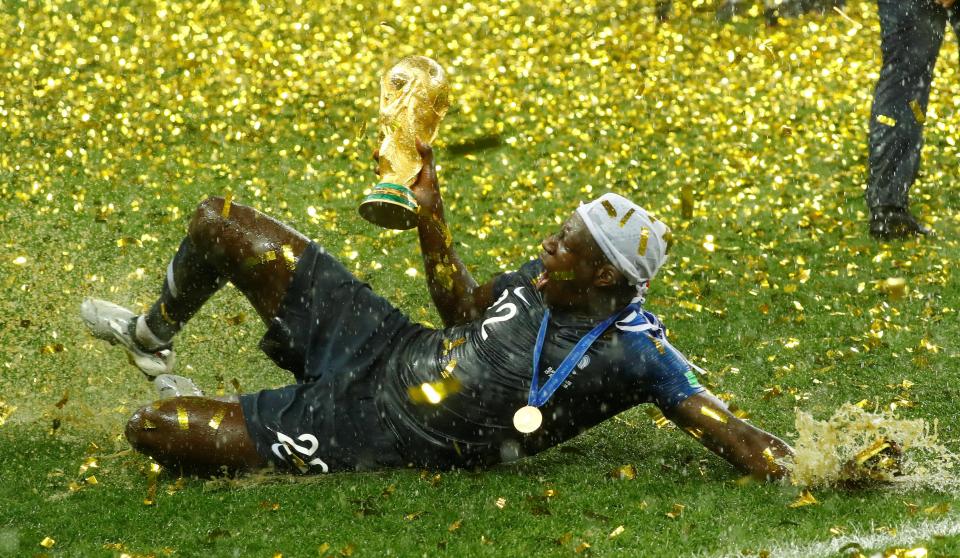 Benajmin Mendy enjoyed the rain as he clung onto the World Cup trophy