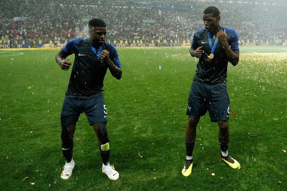 Paul Pogba (R) and France defender Samuel Umtiti dance on the pitch as they celebrate their victory over Croatia