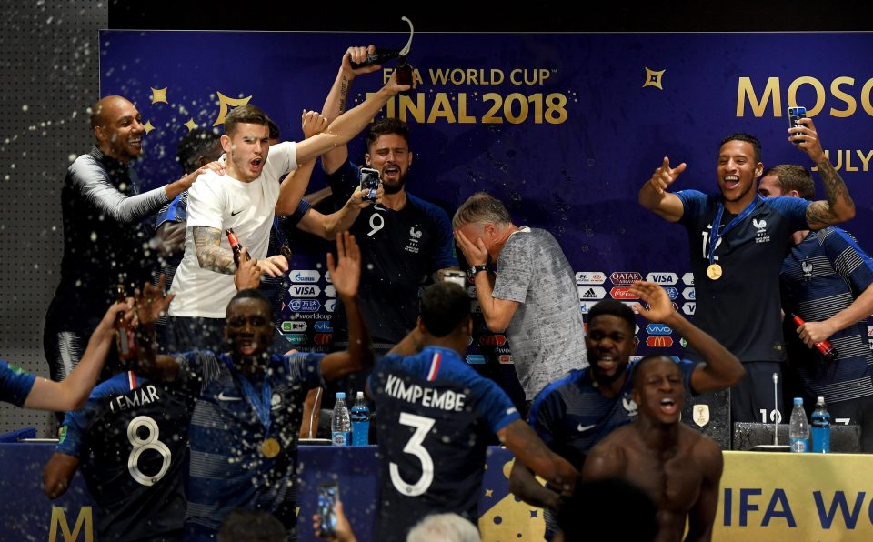  The France squad gathered around their manager in the press conference