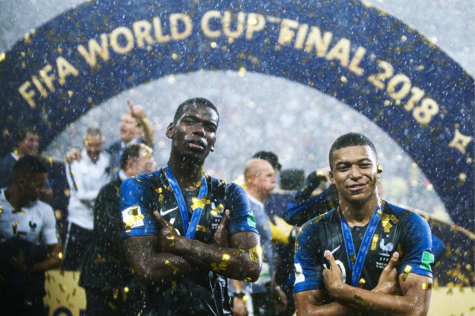 Paul Pogba and Kylian Mbappe both celebrate after winning the World Cup with France