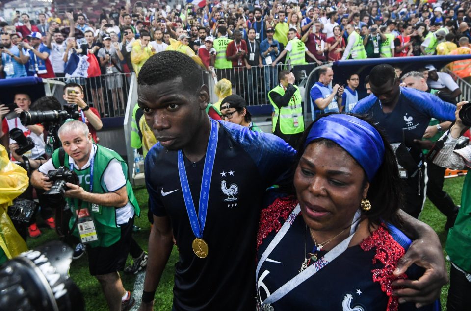 Paul Pogba brings his mother Yeo Moriba on to the pitch to join in the celebrations