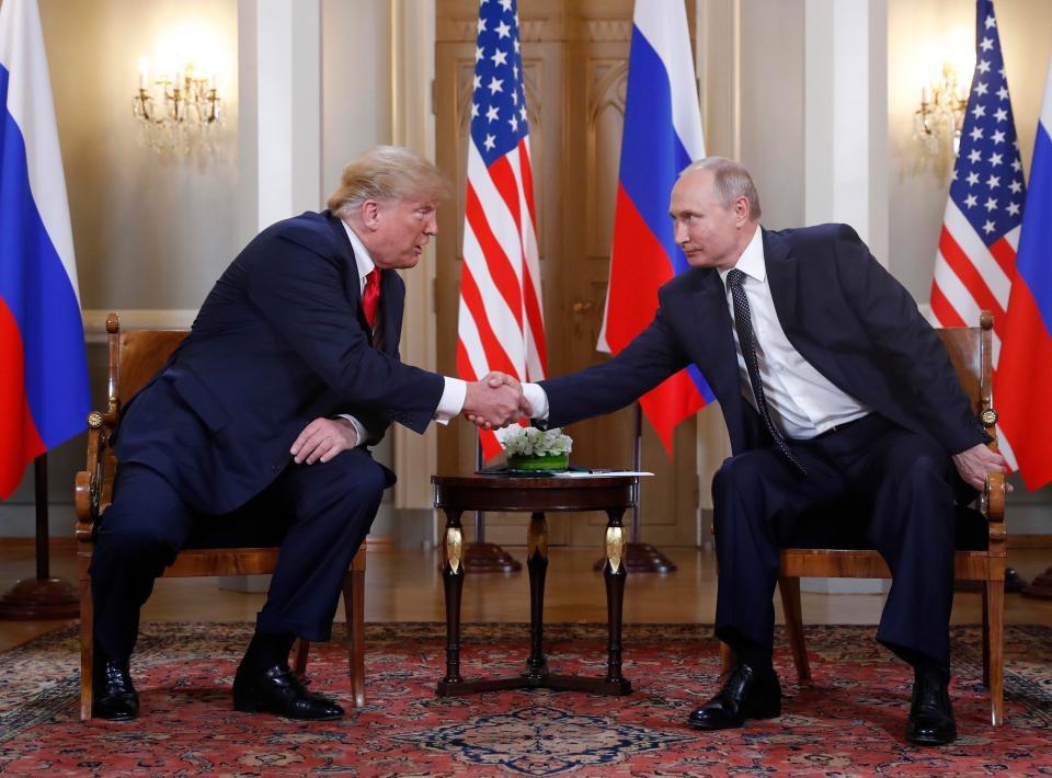  Donald Trump, left, shakes hand with Vladimir Putin as they meet for talks in Helsinki