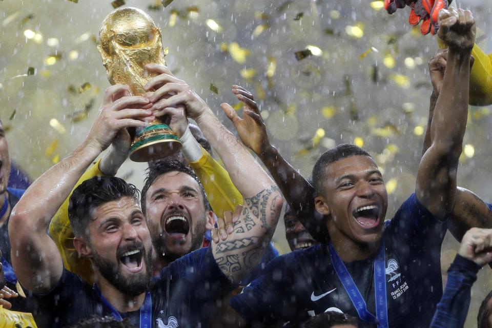 Giroud, left, lifts the World Cup at Moscow's Luzhniki Stadium after France's triumph over Croatia