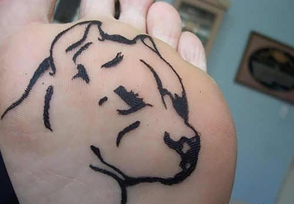  This dog lover got an etching of a pitbull inked onto their sole