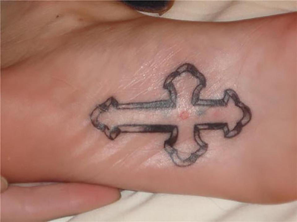  It probably won't help them walk on water but this tat fan had a cross inked onto their foot