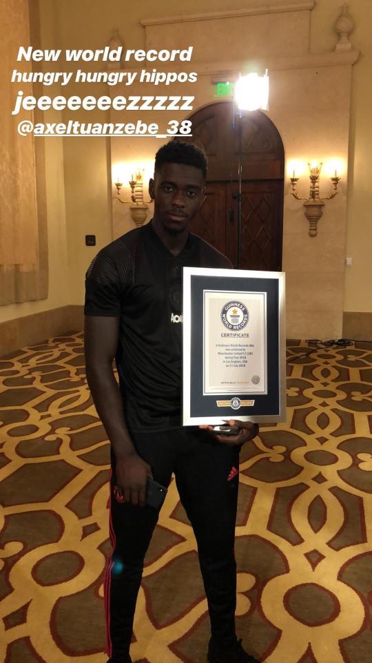  Axel Tuanzebe stood proudly holding up an official Guinness World Record certificate