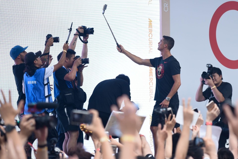 Cristiano Ronaldo used a selfie stick to get a group shot with fans