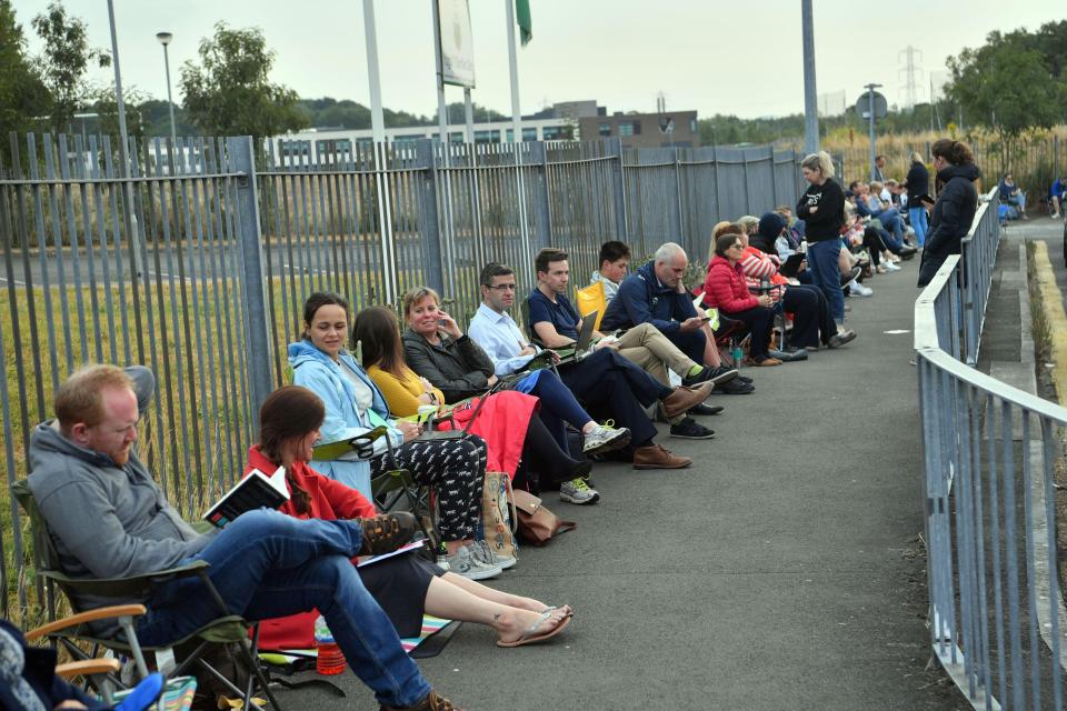  Determined parents lined the kerb to secure a place for their child at the sought after club