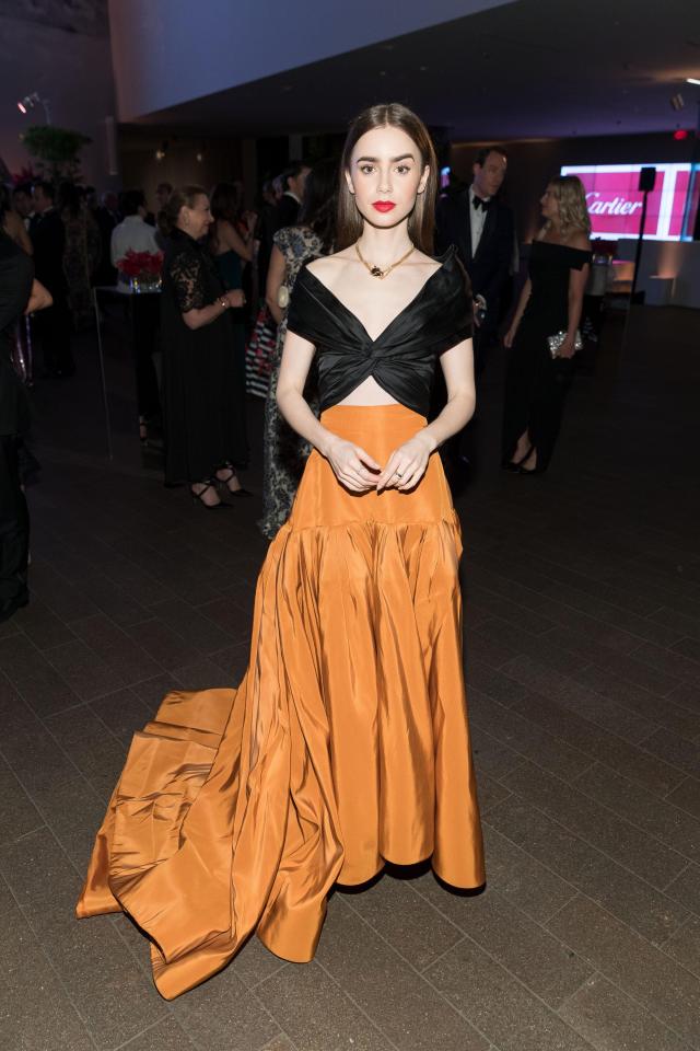 Lilly Collins wears a luxurious terracotta-coloured skirt to the Mid-Winter Gala 2018