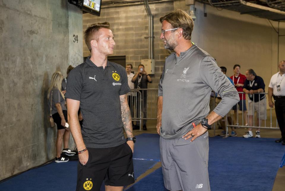 Jurgen Klopp catches up with Marco Reus who he managed at Dortmund