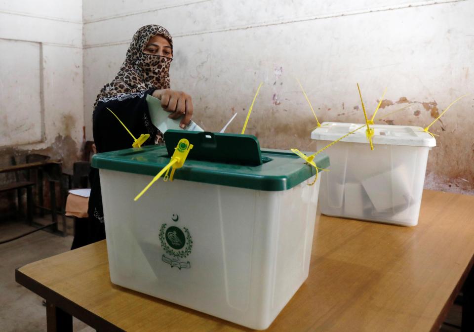  A woman votes during the general election in Karachi, Pakistan