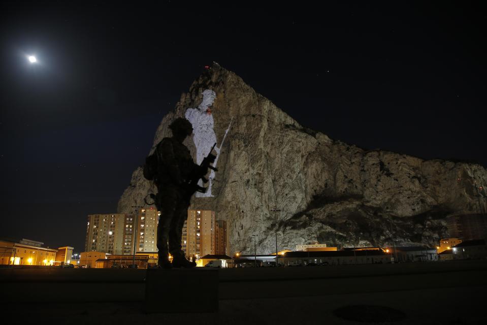  A British soldier poses in front of the striking silhouette projected on the Rock