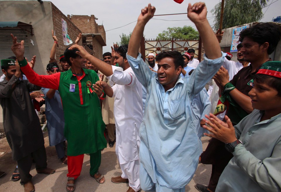 Supporters of politician Imran Khan celebrate claims of his victory