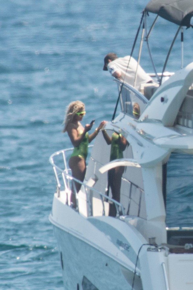 She then changed into a green swimsuit