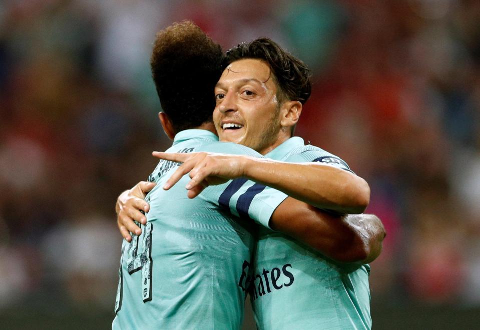  Ozil, 29, celebrates with team-mate Pierre-Ermerick Aubameyang following a deadly counter-attack