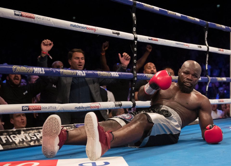  Takam is left on the floor as Eddie Hearn celebrates in the background