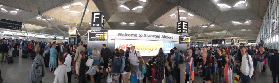  Frustrated passengers wait for another announcement at Stansted Airport