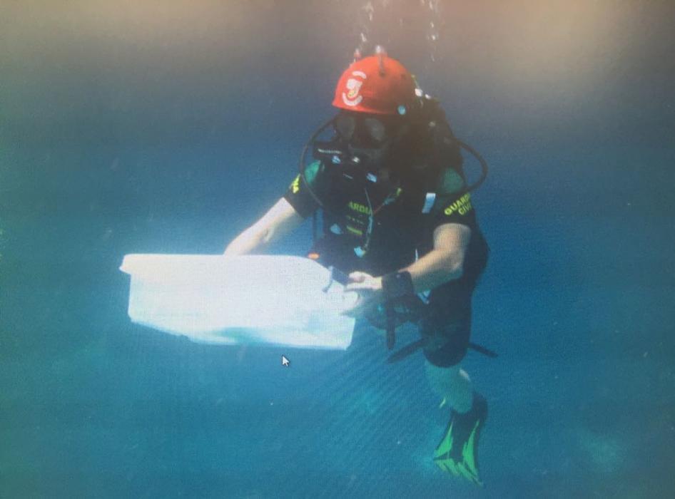  Divers off the coast of Majorca look for the severed arm of a German tourist