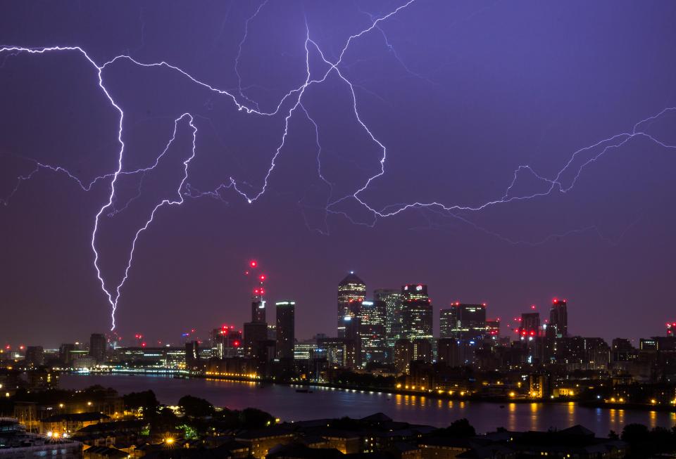  Lightning strikes over Canary Wharf and the River Thames in London