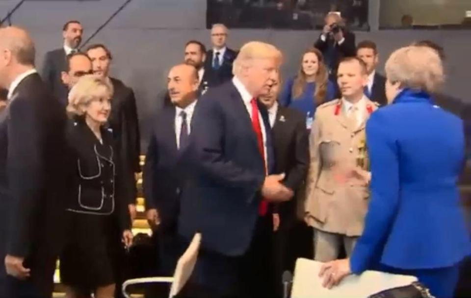  The US President goes in for a handshake but gets ushered by Theresa May towards Jeremy Hunt