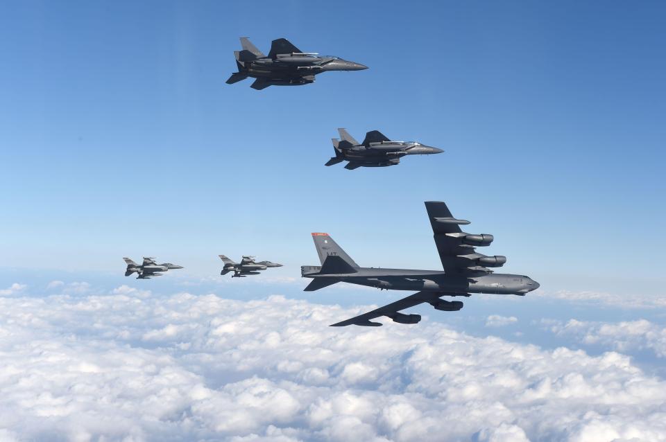  US B-52 Stratofortress (bottom R) flying with South Korean F-15K fighter jets (top) and US F-16 fighter jets (bottom L) over South Korea