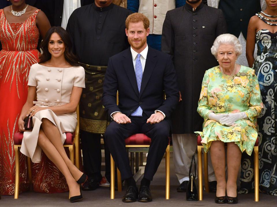  The Queen with the Duke and Duchess of Sussex during a group photo at the Queen's Young Leaders Awards Ceremony