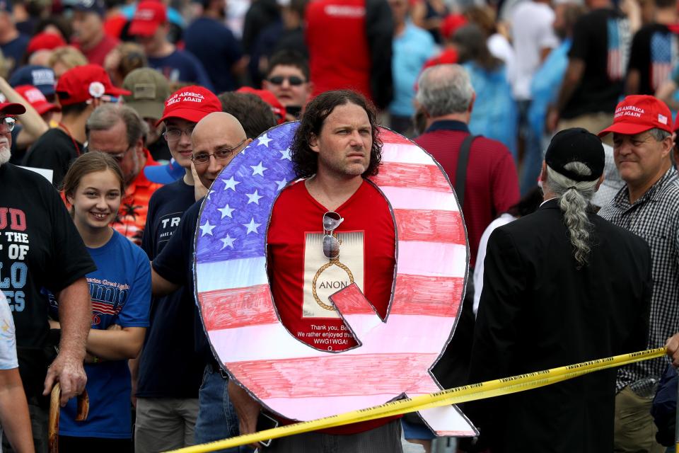  QAnon are a regular fixture at Trump rallies where they wave massive signs or wear tops emblazoned with the letter