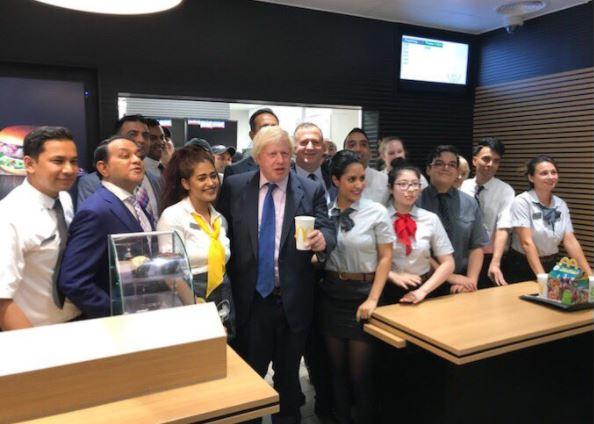  The former cabinet minister posed with McDonalds staff after cutting the ribbon