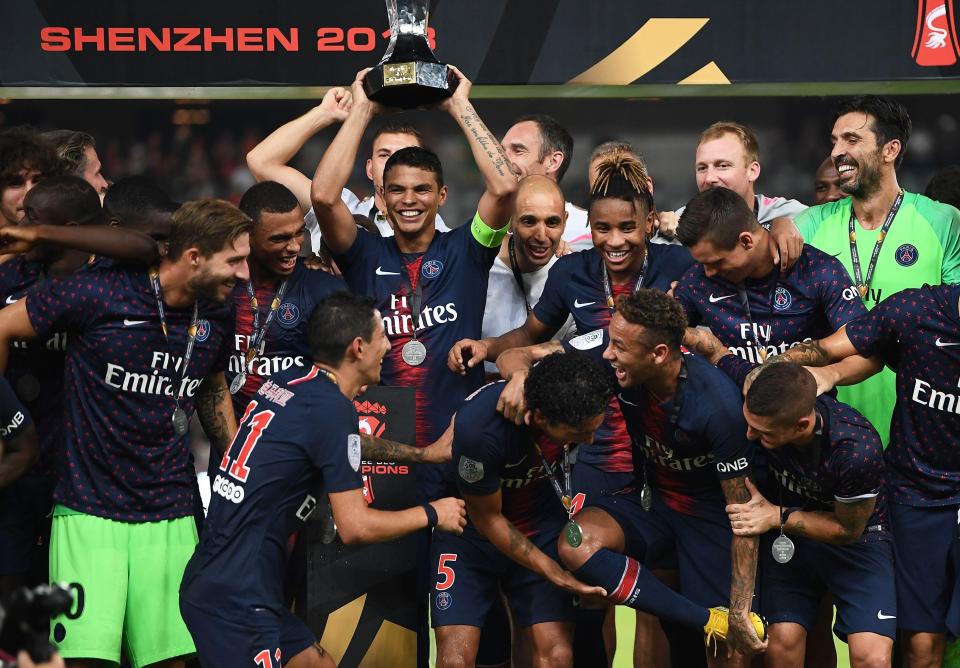  Neymar shares a joke with Angel Di Maria on the podium after PSG beat Monaco 4-0 in the Trophee des Champions