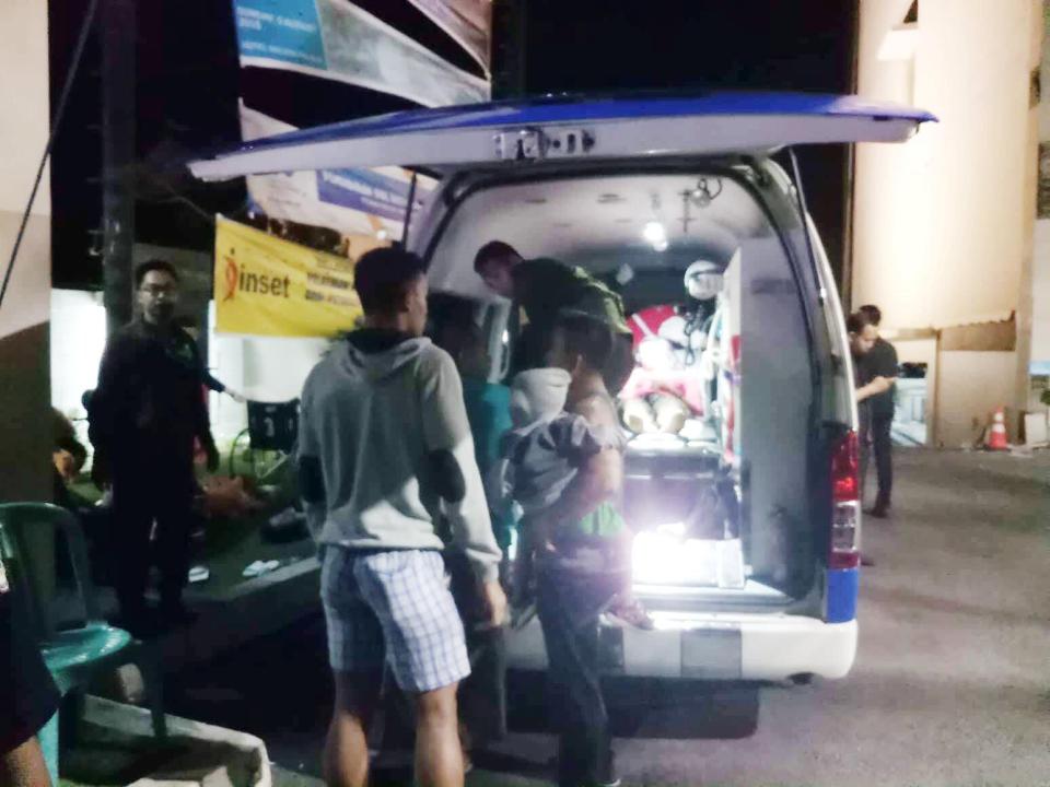  People are seen next to the ambulance near the Golden Palace Hotel