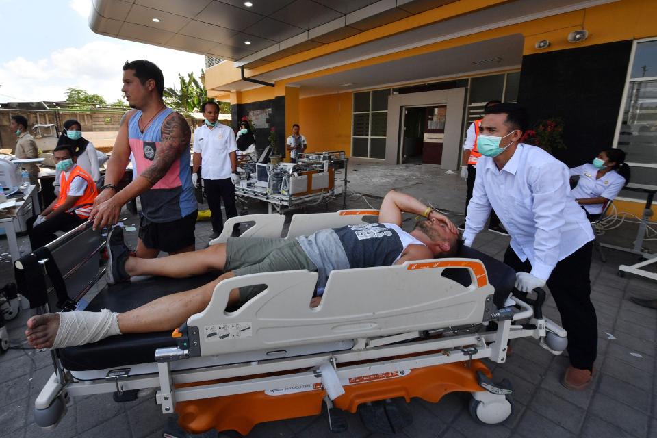  A tourist gets medical attention at a makeshift unit set up outside the Moh Ruslan hospital on Lombok island