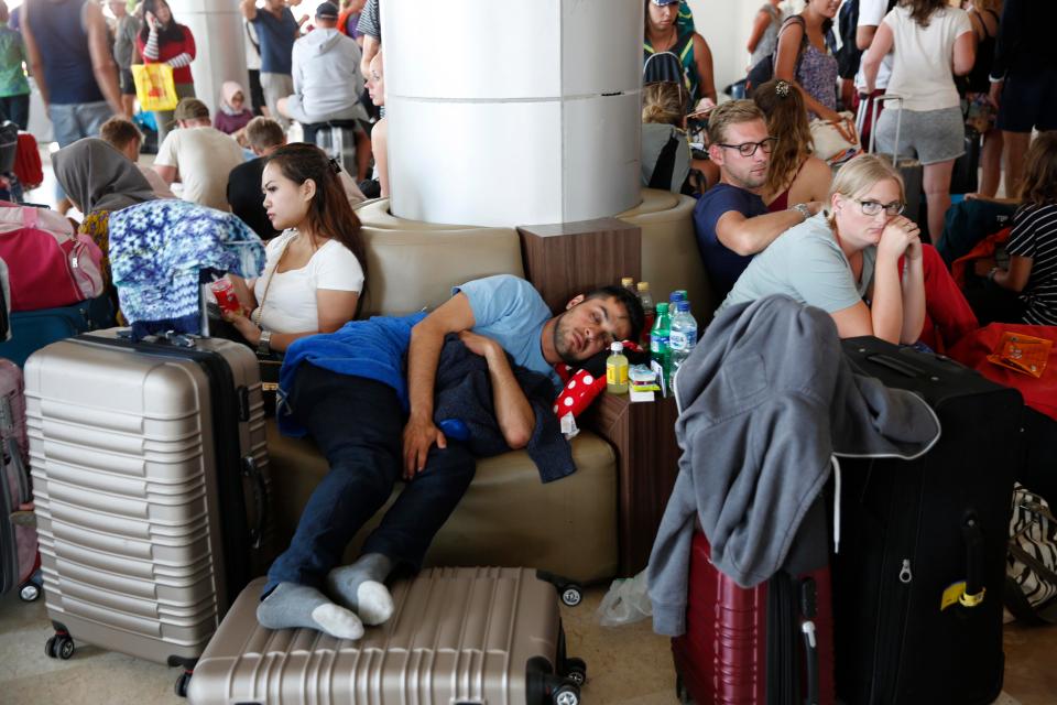  Thousands of holidaymakers were caught up in the tremors and some are stranded on the smaller islands. These tourists are waiting to check in at Praya International airport in Lombok