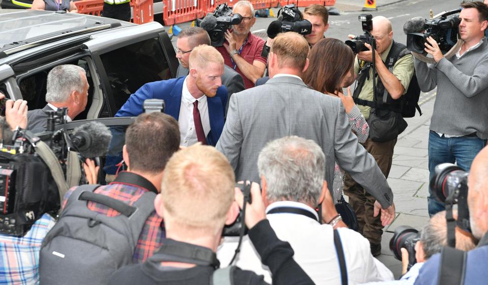  The all-rounder walks through a crowd of photographers at the court today