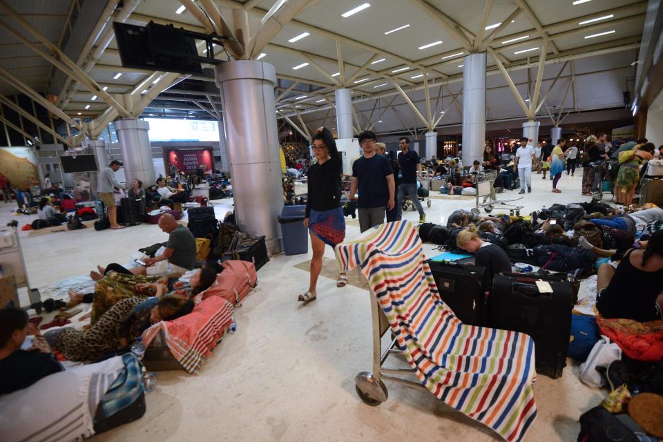  Foreign tourists rest while waiting to depart from the Praya Lombok International Airport