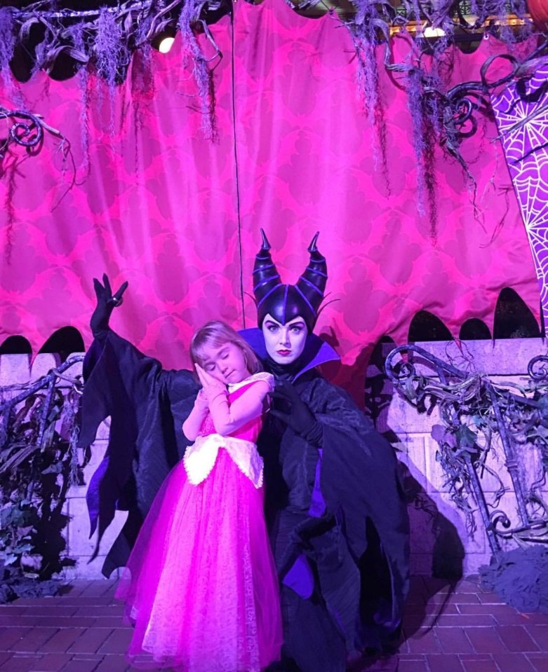 Riley dressed as Sleeping Beauty, posing with a Disney worker dressed as Maleficent