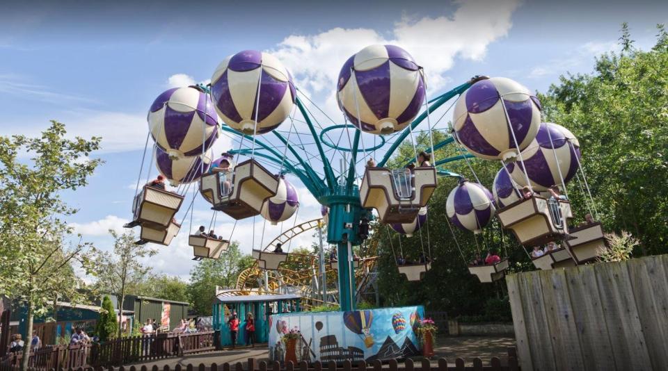  Families enjoying the magical hot air balloons of The Whirlwind in Adventure Land