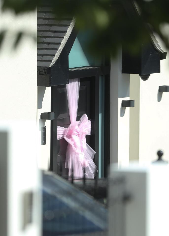  A pink ribbon hangs outside Kane's house in a nod to his newborn daughter