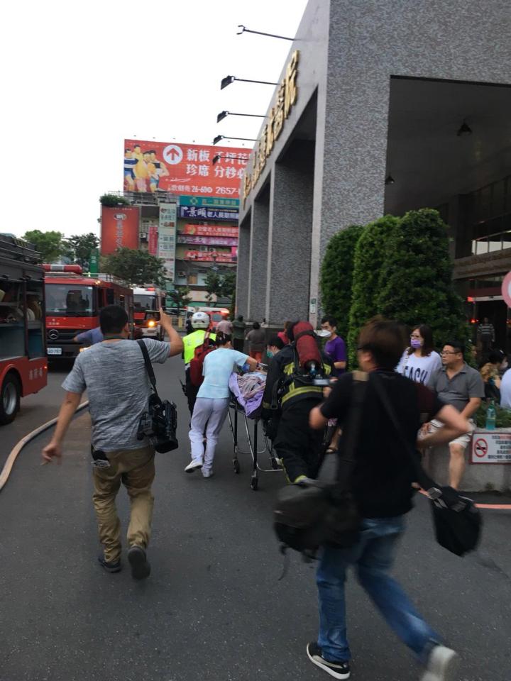  A patient is rushed to a waiting ambulance after a fire broke out at the Taipei Hospital