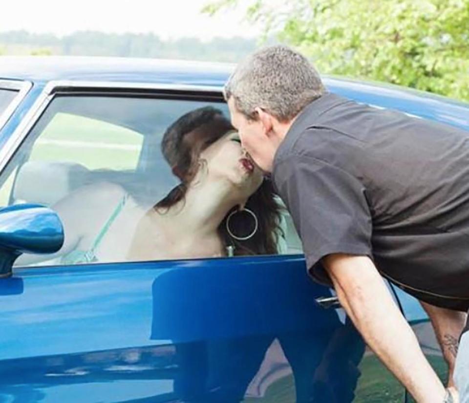  Not even a car window can stop the love this pair have for each other