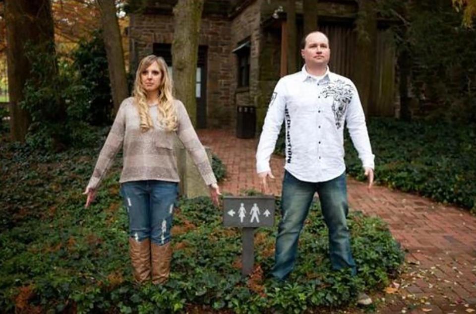  This couple appear like statues to recreate the male and female signs for toilets