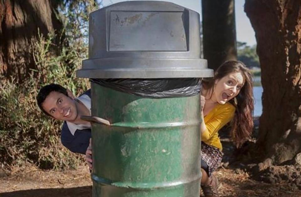  This couple peek from behind a public rubbish bin in this cheesy set-up